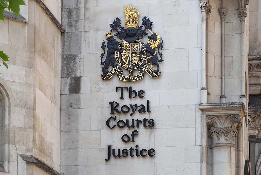 Close-up of the exterior sign of the Royal Courts of Justice