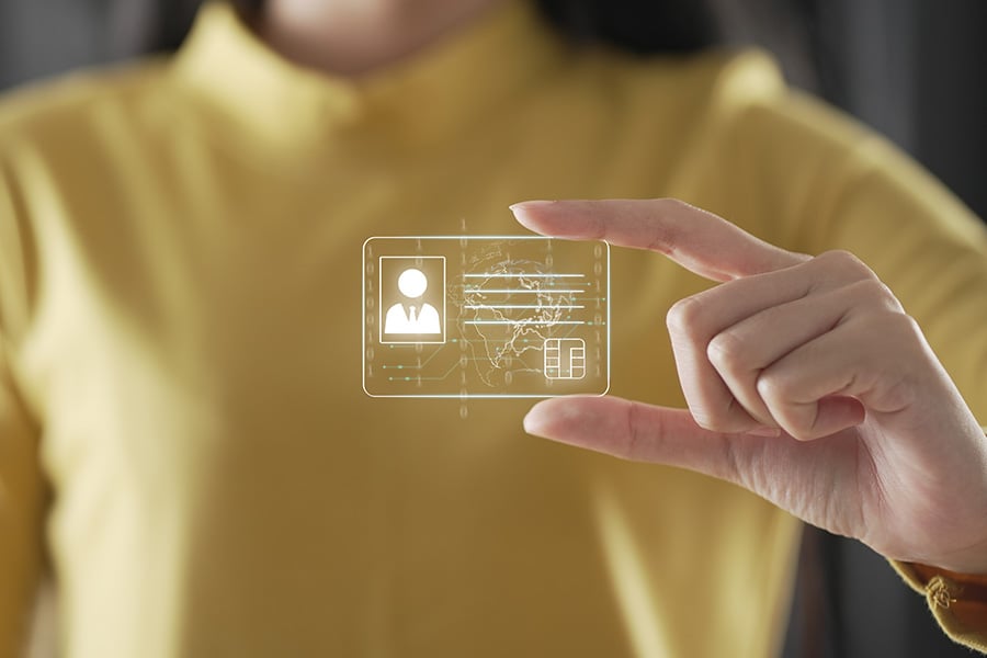 A woman appears to be holding a holographic digital ID card