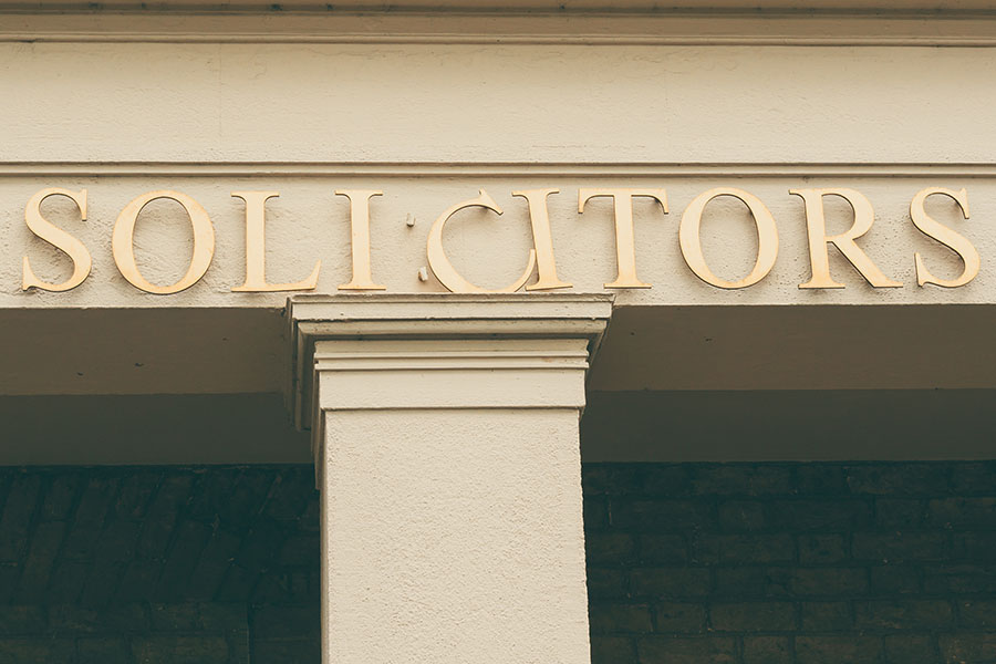 The word 'solicitors' spelled out in signage with one of the letters slightly wonky
