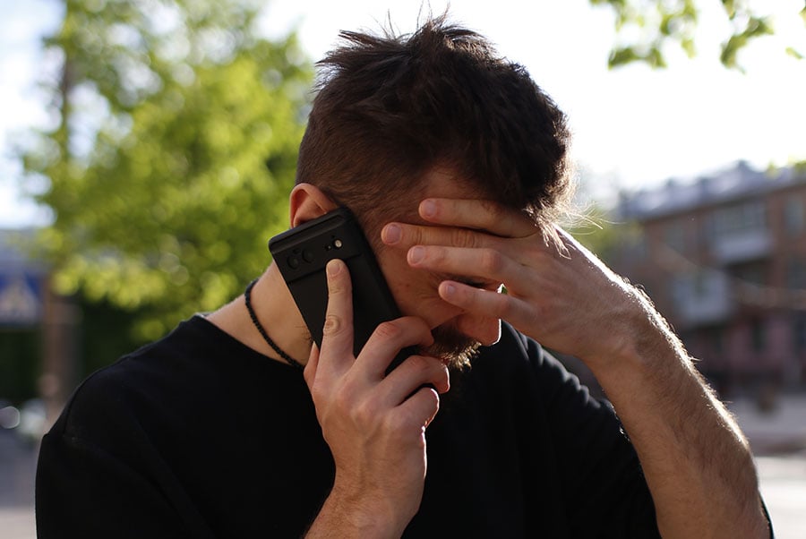 A dejected or sad man on the phone looks like he is receiving bad news