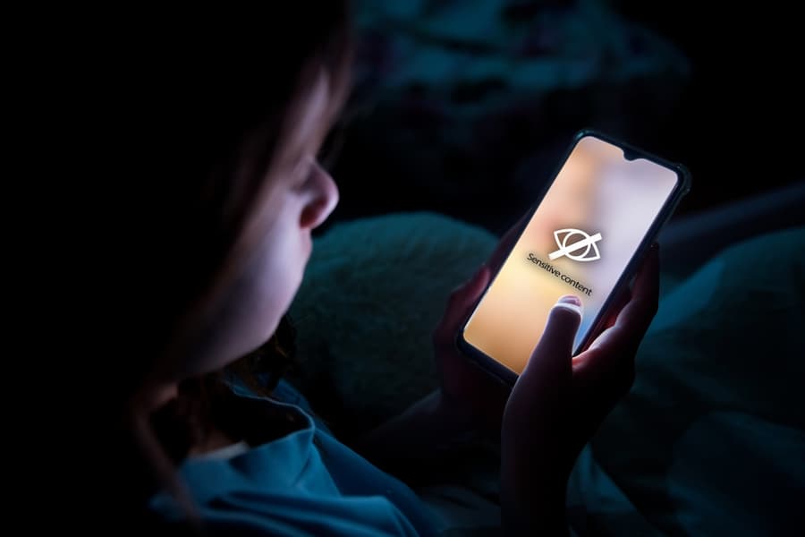 Child watching sensitive material on a phone screen