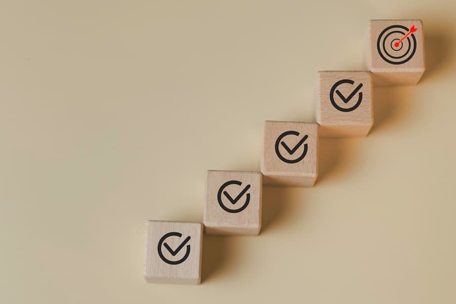 Goal achievement and business success concept with step by step checklist leading to target