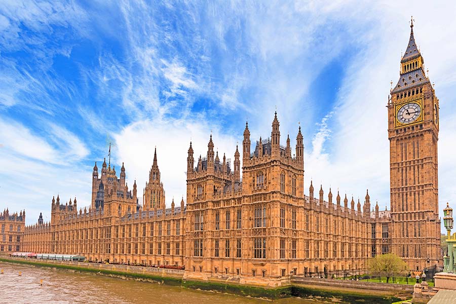 A wide shot of the exterior f the houses of parliament
