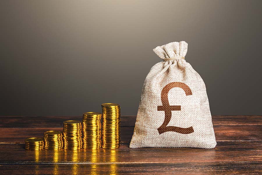 Increasingly large piles of gold coins next to a sack marked with a pound sign