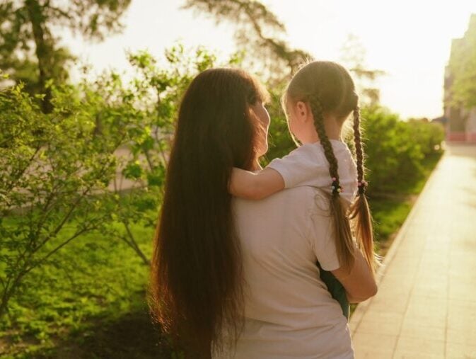Mum carrying child